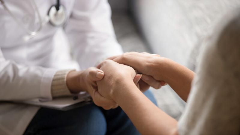 Close,Up,Horizontal,Image,Doctor,In,White,Uniform,Holding,Hands